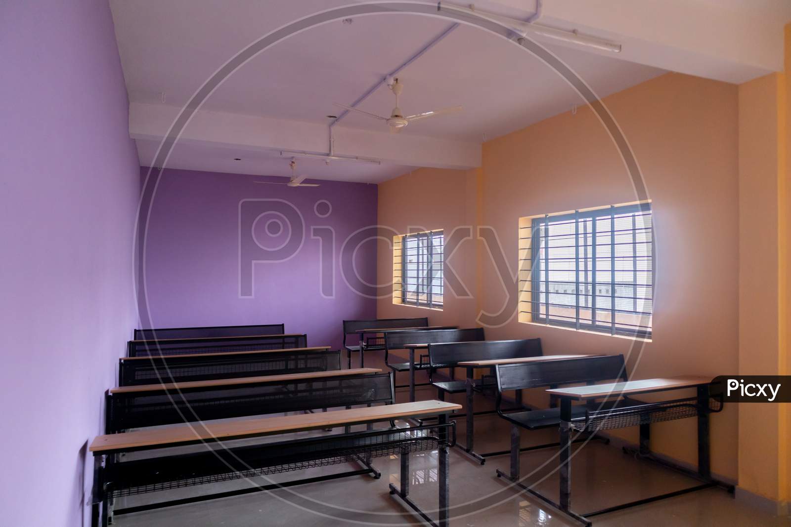 Empty Class Room And Desks With Colorful Walls