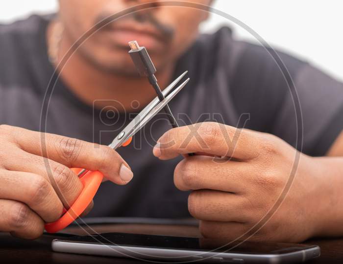 Close up shot of a Person cutting USB Charging Cable