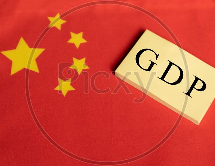 Gross Domestic Product Or Gdp Of China On Wooden Block Letters On Chinese Flag.
