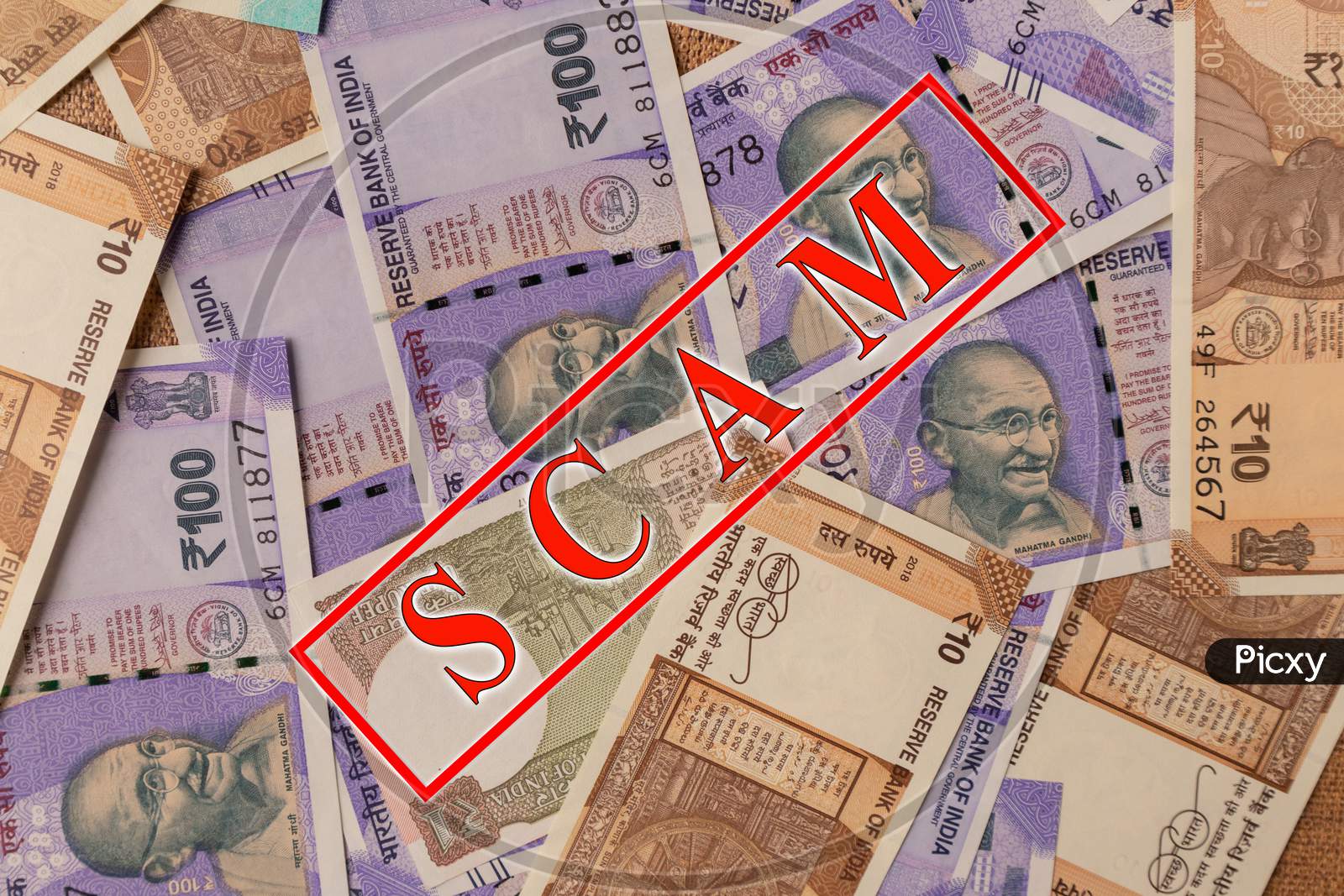 Scam And Money Concept, Scam In Red Alphabets Printed On Indian Currency Notes.
