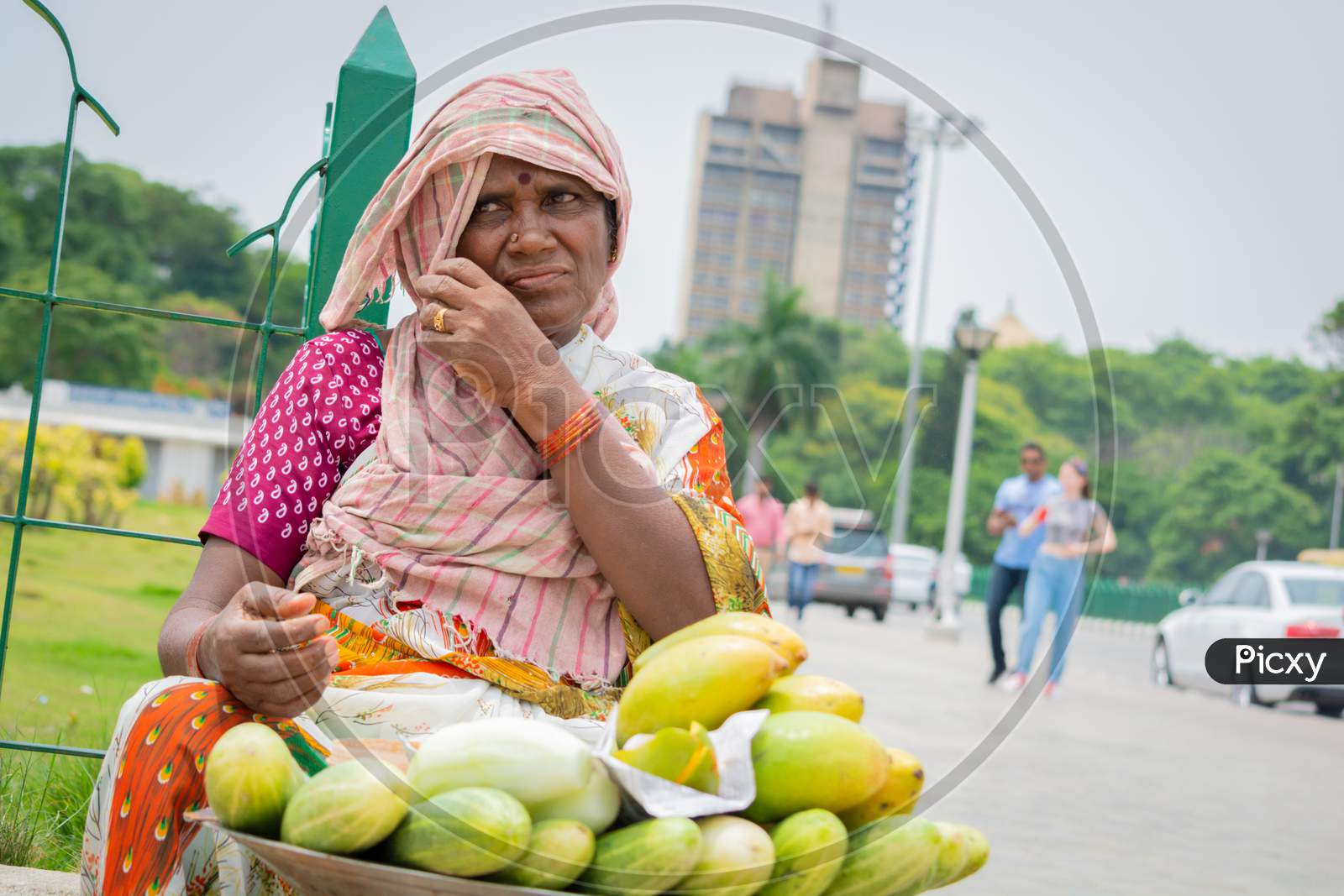 Bangalore, Karnataka India-June 04 2019 :Street Vendor Woman Selling Mango'S And Cucumber At Hot Sunny Day At Bangalore, India.