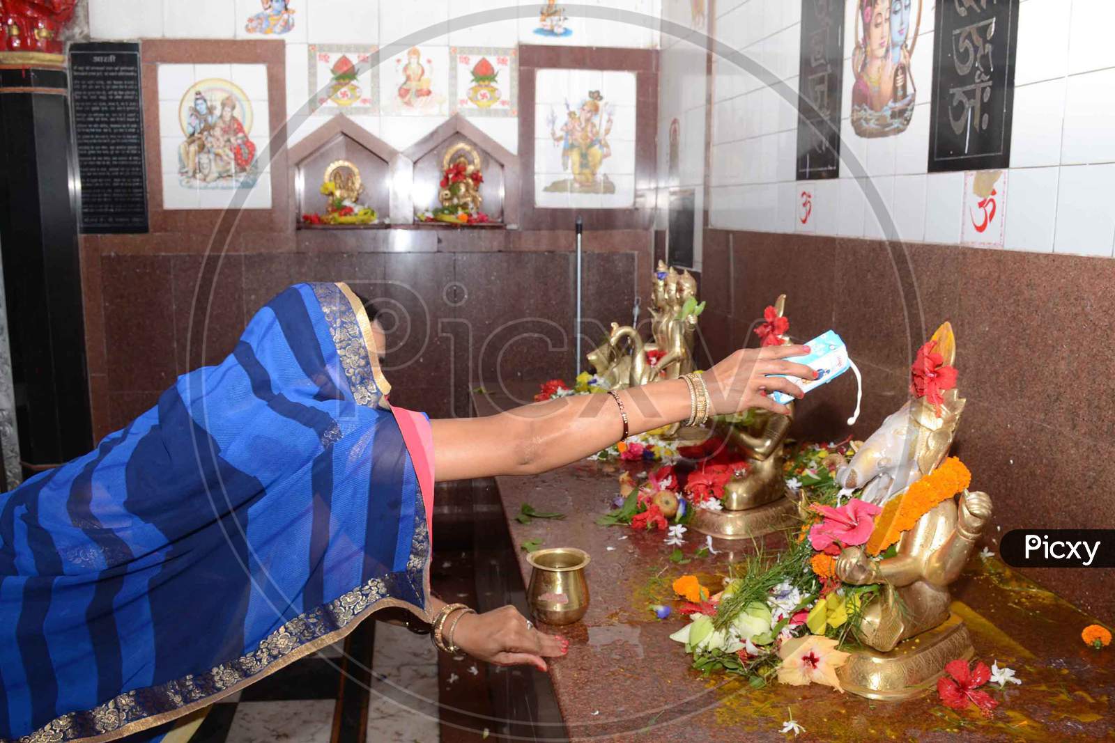 Devotees Offer Prayers At Sukerswar Temple After The Authorities Permitted Opening Of All Religious Places With Certain Restrictions, During The Fifth Phase Of Ongoing Covid-19 Lockdown, In Guwahati, Monday, June 8, 2020.