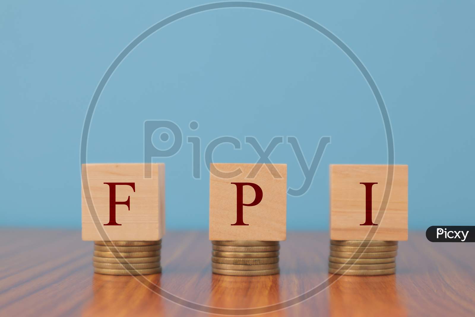 Concept Of Fpi Or Foreign Portfolio Investment In Wooden Block Letters On Stack Of Coins.