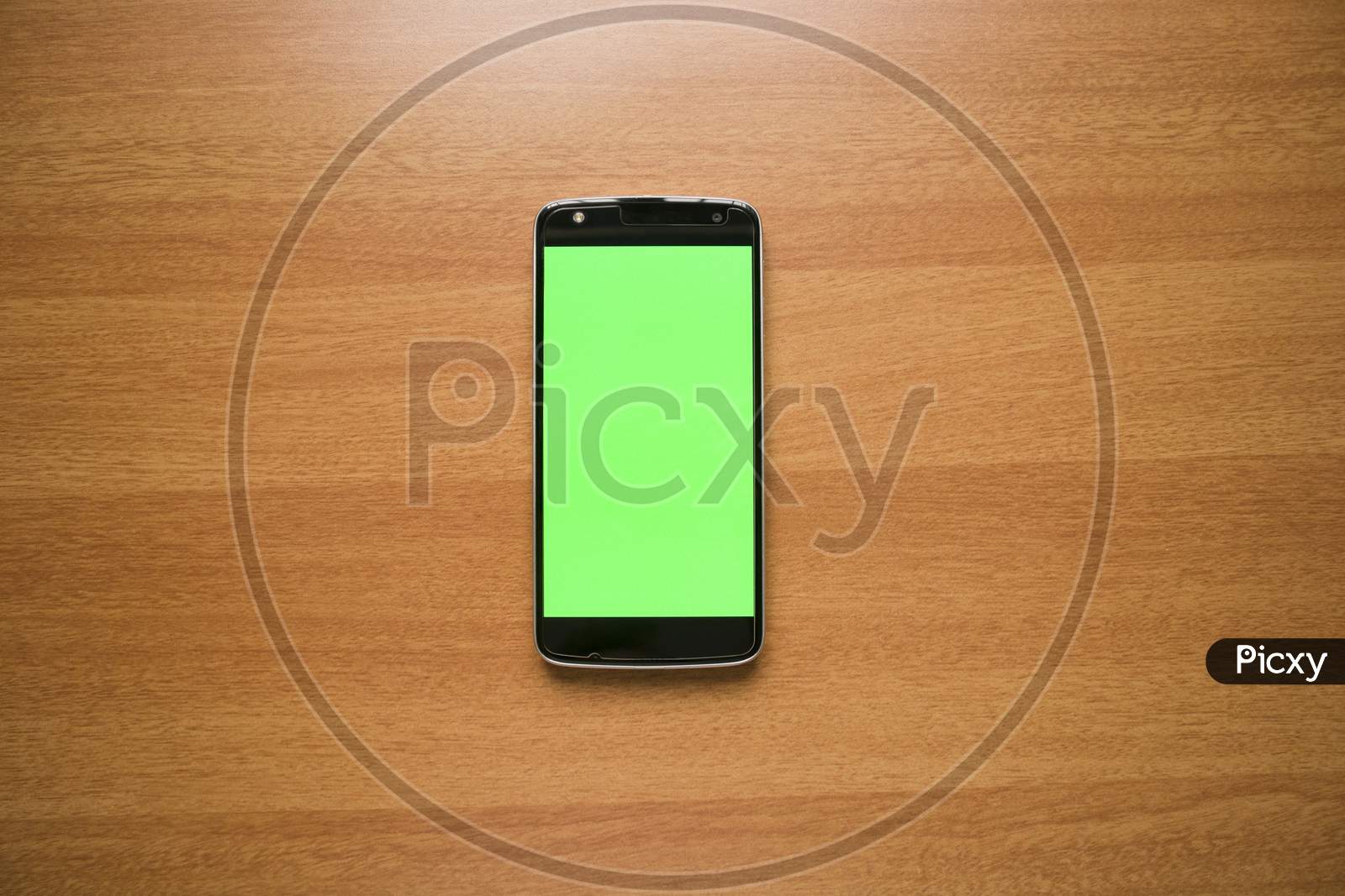 Green Mockup Telephone Or Mobile Phone On Table.