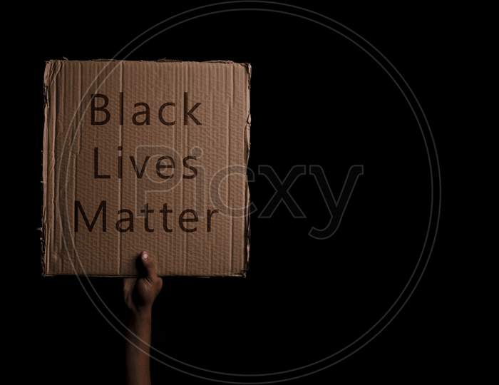 A kid holding Black Lives Matter placard