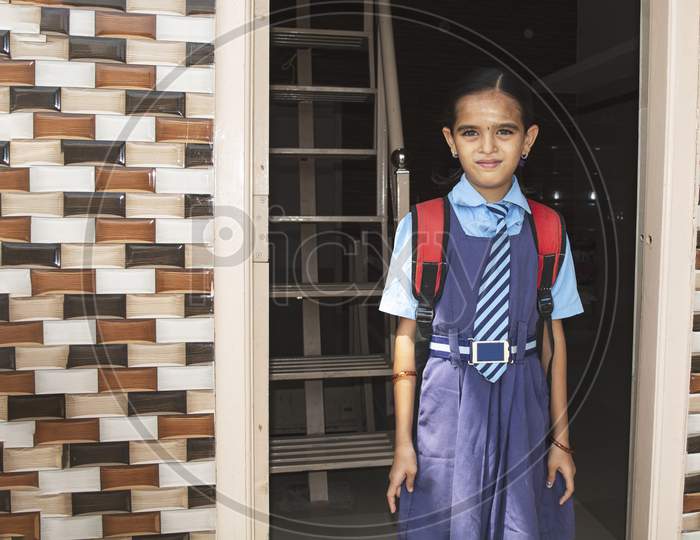 A Young Girl Ready With Uniform - Small Kid Leaving Home For School - Concept Of Back To School And Starting Kindergarten.