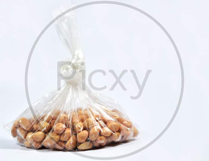 Raw Arachis Hypogaea,Peanut Or Groundnuts In A Bag On Isolated White Background.