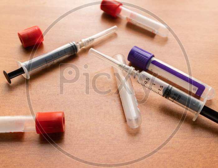 Plain Clot Bloot Activators And Syringe'S On Wooden Textured Table In Laboratory, India