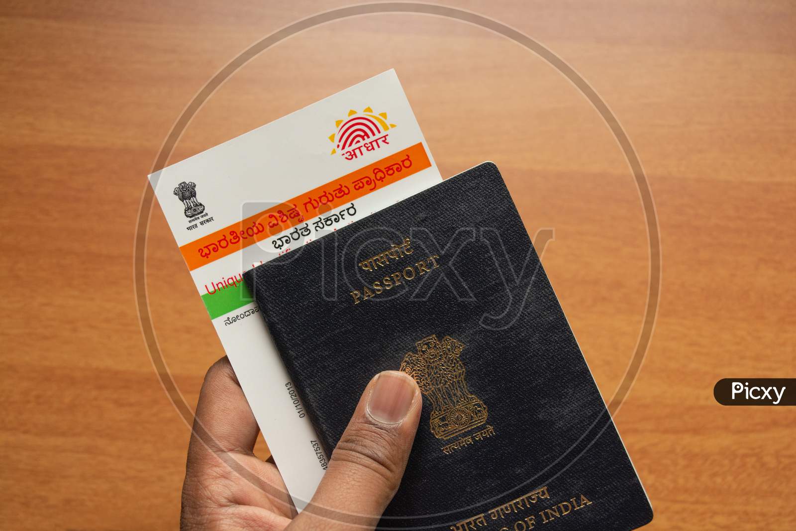 Holding Aadhaar Card And Passport Which Is Issued By Government Of India As An Identity Card To Travel Foreign.