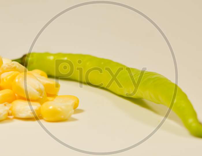 Close up shot of Peeled sweet corn with chilli isolated with the White Background