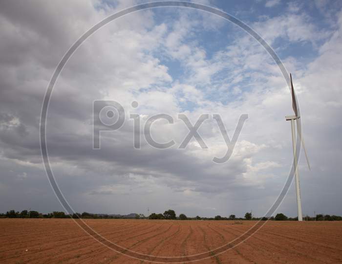 The landscape of an Agriculture Fields with A Windmill