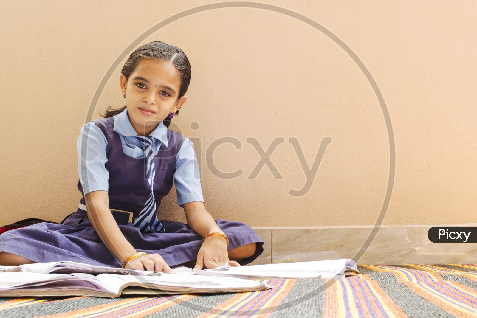 A Beautiful Young Girl Reading With School Dress At Home - School Kid Doing Home Work - Girl Kid With Books And Uniform.