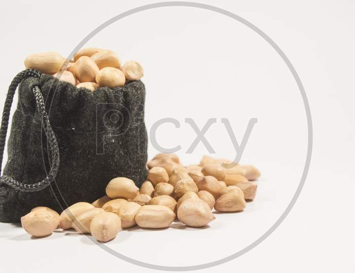 Peanuts In Burlap Bag Isolated On White Background