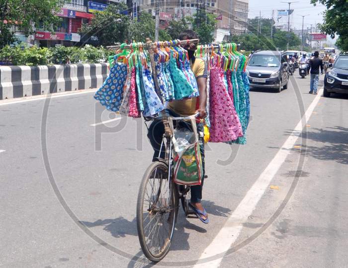A Man Carries Clothes On His Bicycle For Sale During The Fifth Phase Of Covid-19 Nationwide Lockdown In Guwahati On June 8,2020.