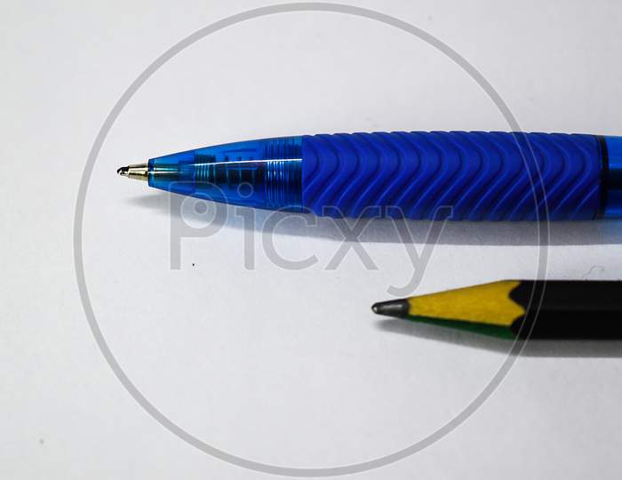 Black Pencil And Blue Pen Isolated On White Background. Selective Focus Applied.