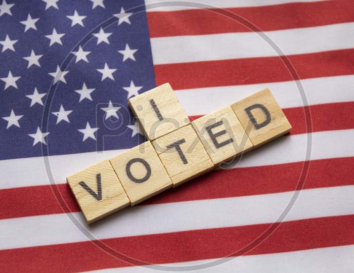 I Voted Wooden Block Letters,Us Elections On American Flag.