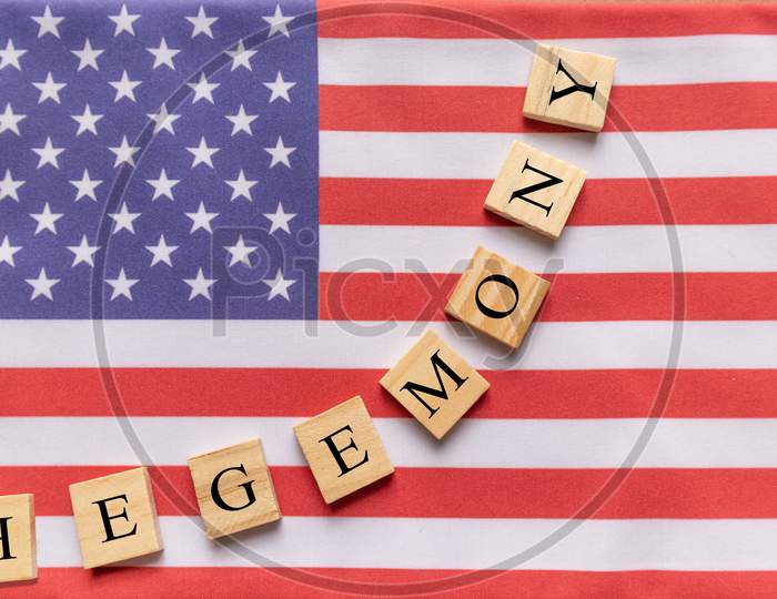 Concept Of Us Hegemony, Hegemony In Wooden Block Letters On Us Flag