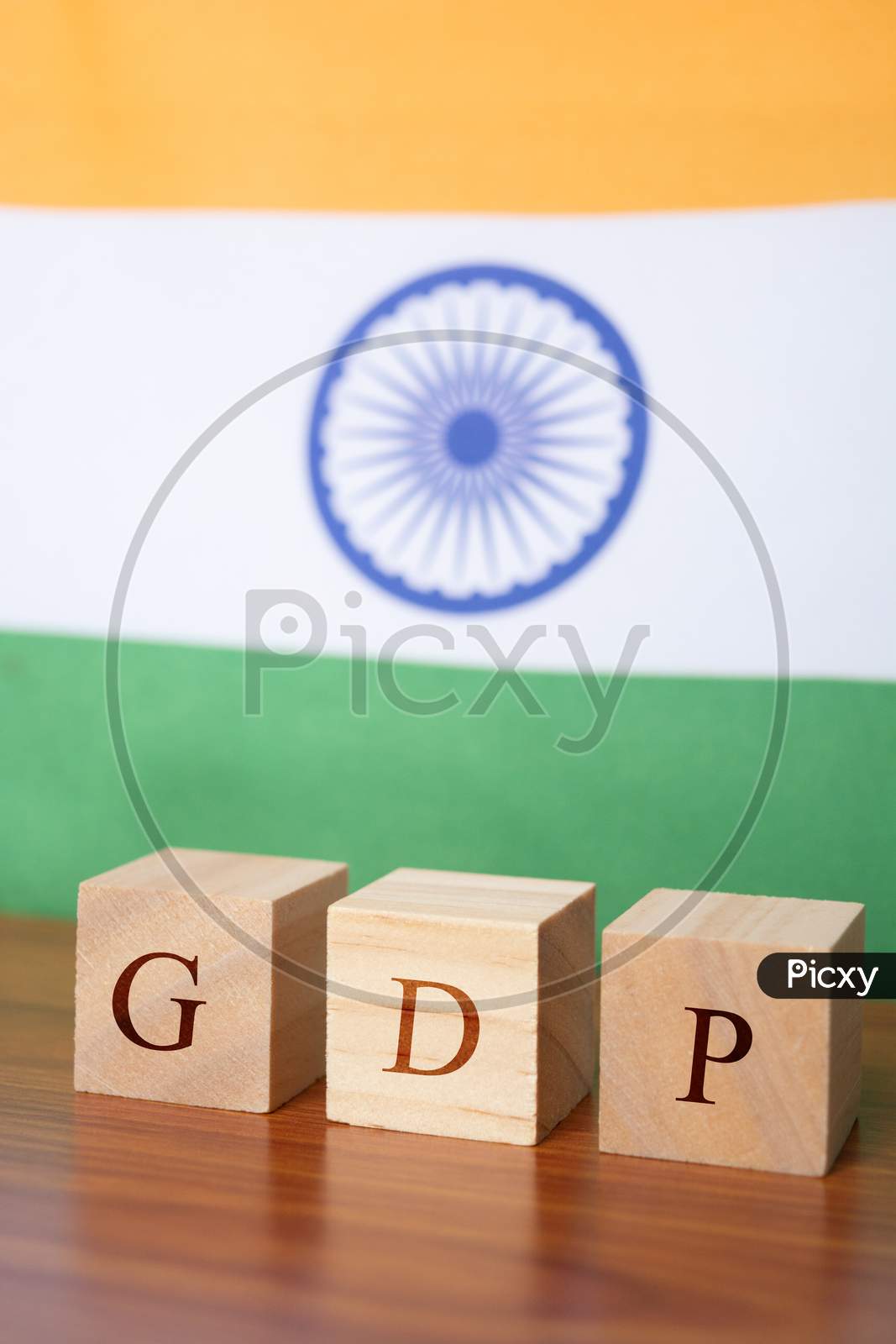 Gdp Or Gross Domestic Product In Wooden Block Letters, Indian Flag As A Background.