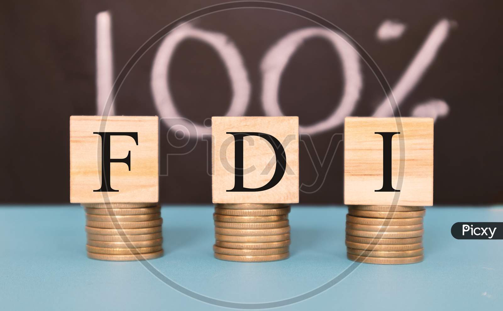 Finance Concept With Stack Of Coins - 100 Percent Fdi Or Foreign Direct Investment On Wooden Blocks.