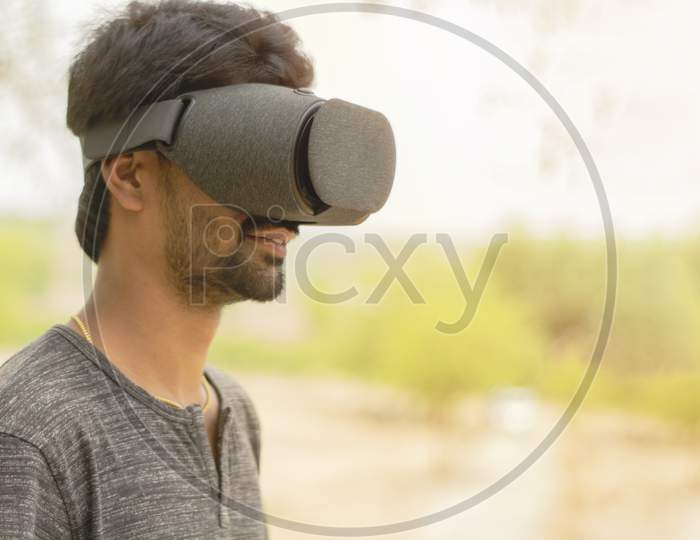 Young Man Using A Vr Headset Glasses Outside
