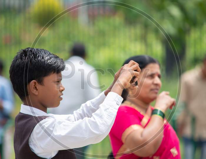 Bangalore, Karnataka India-June 04 2019 : Indian Boy Trying To Taking A Photo With His Smartphone At Vidhana Soudha Bengaluru. Child Using Mobile Phone In The Public Park.