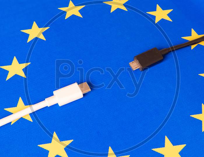 Close Up Mobile Phone Charger USB and Type - C Cord On Eu Flag