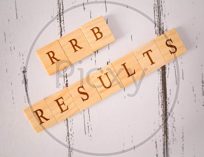 Concpet Of Rrb Exam Conducted In India For Recruitment, Rrb Exam Results On Wooden Block Letters.