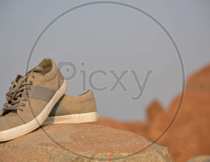 Stylish Men Olive Green Sneakers Or Regular Shoes On Top Of The Mountain.