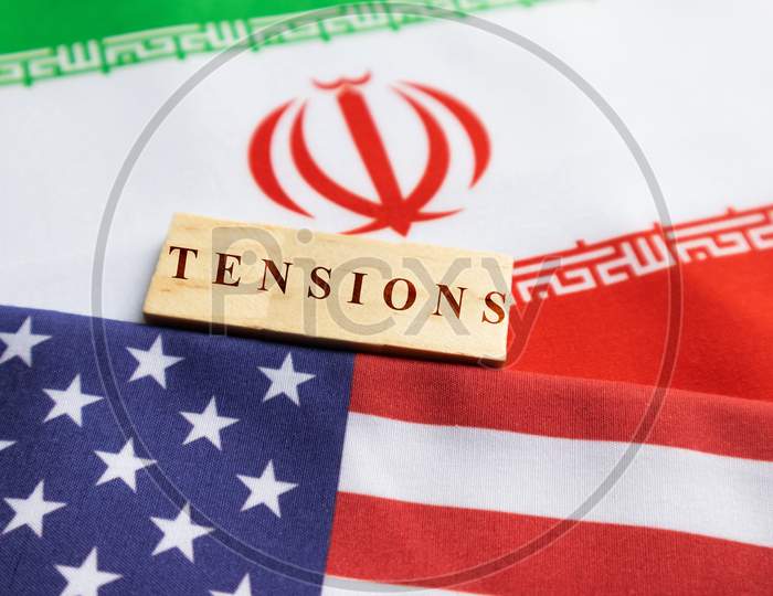 Concept Of Bilateral Relations Of Us And Iran Showing With Flag And War With Wooden Block Letters