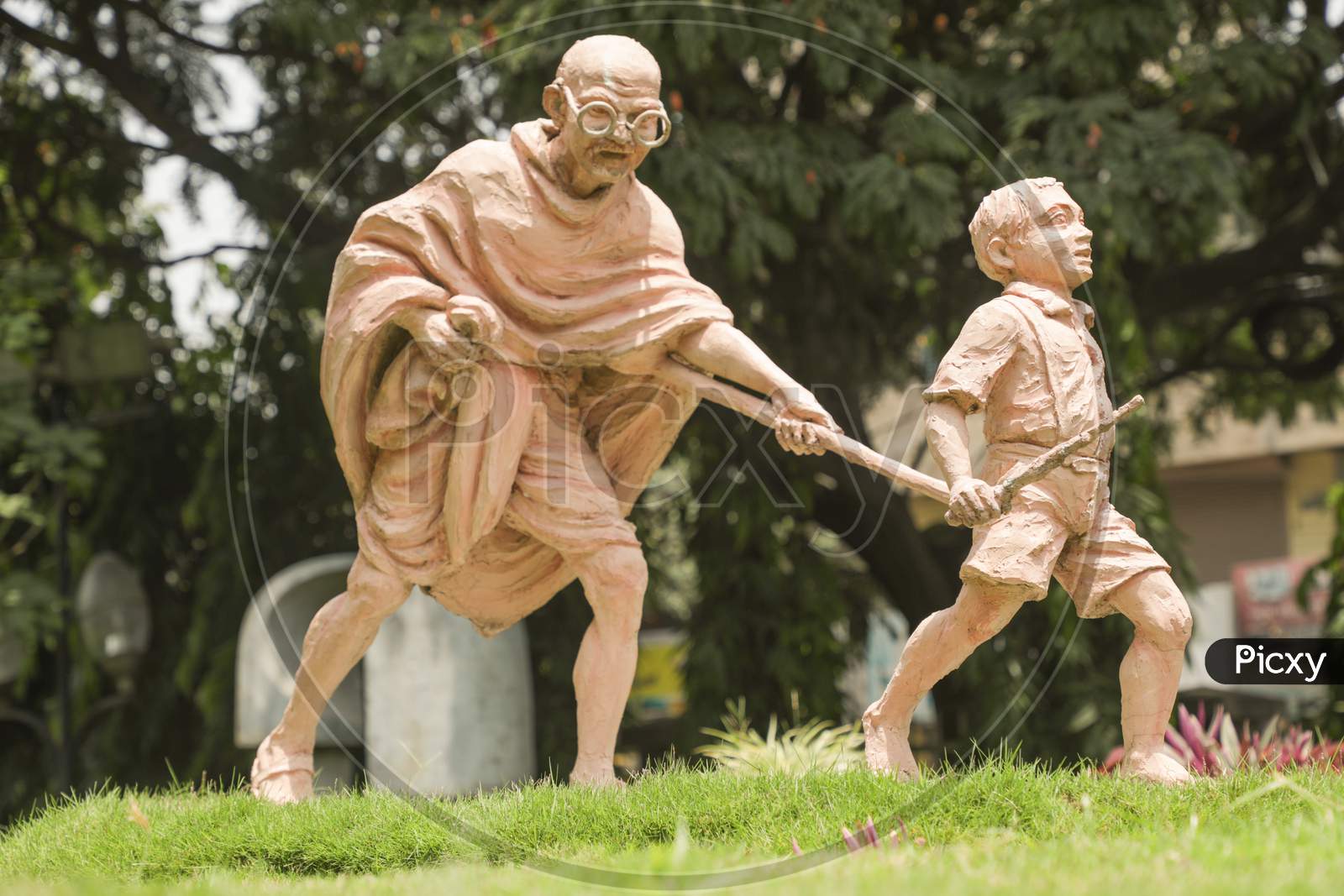 Sculpture Of Mahatma Gandhi And Child, Child Moving By Holding The Stick Of Mahatma Gandi At Bengaluru, India.