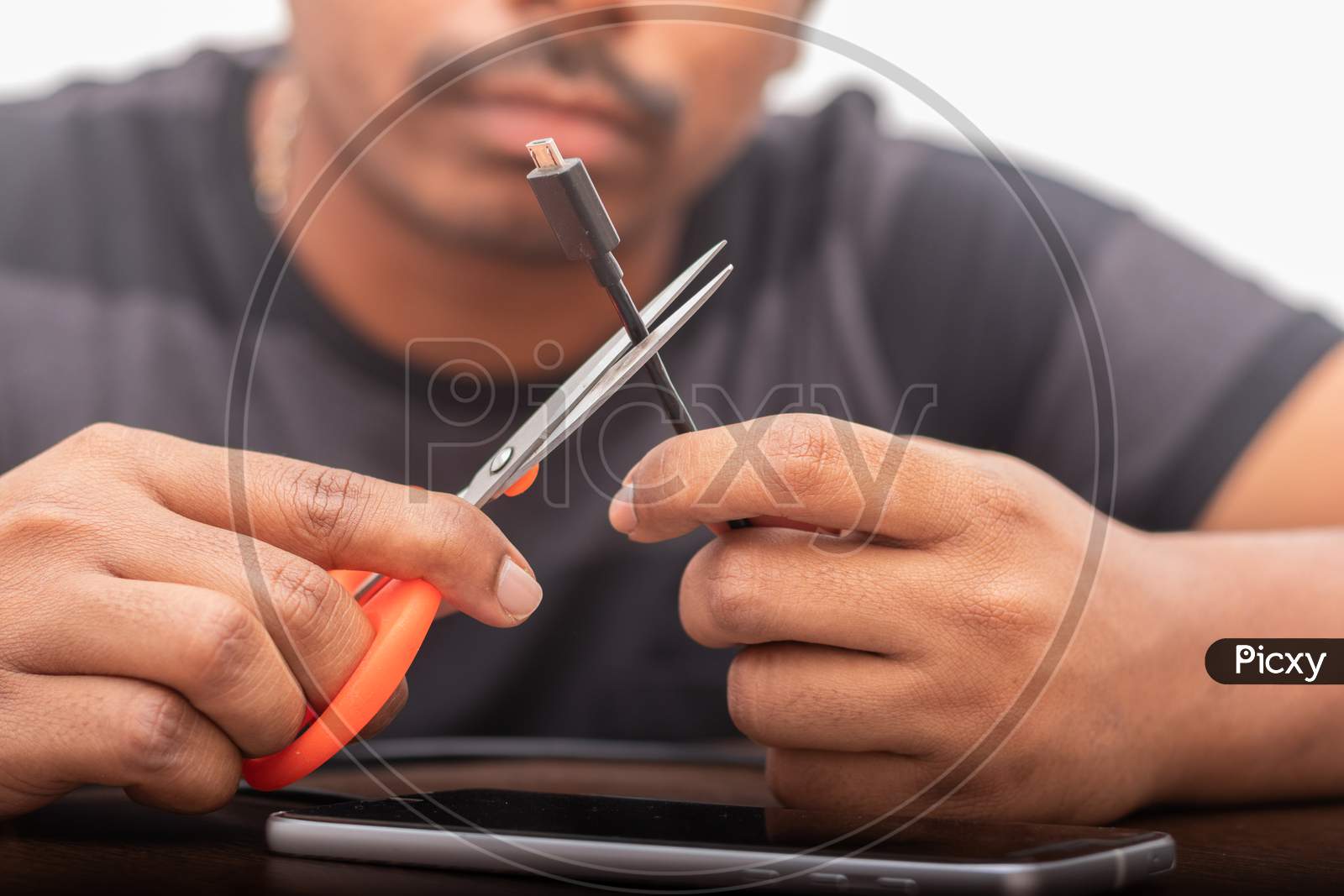 Close up shot of a Person cutting USB Charging Cable