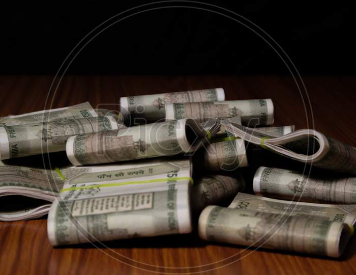 Concept Of Black Money Showing Pile Of Indian Currency On Table In Dark Room.