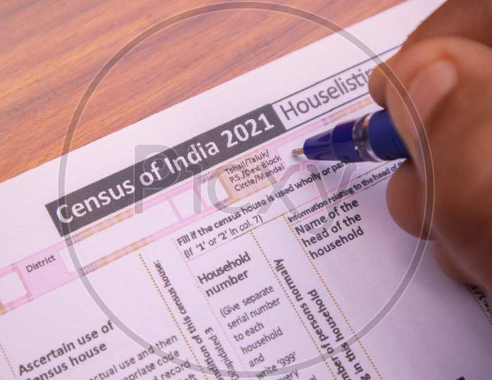 Close Up Of Hands Filling Up The Census Of India 2021 Form Or Npr At House For Population Register At India.
