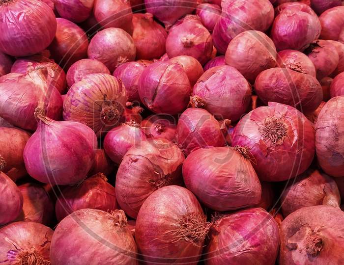 Red Onions Spread Across In The Market,Full Frame,Vertical Picture, Beautiful Background Theme. Selective Focus