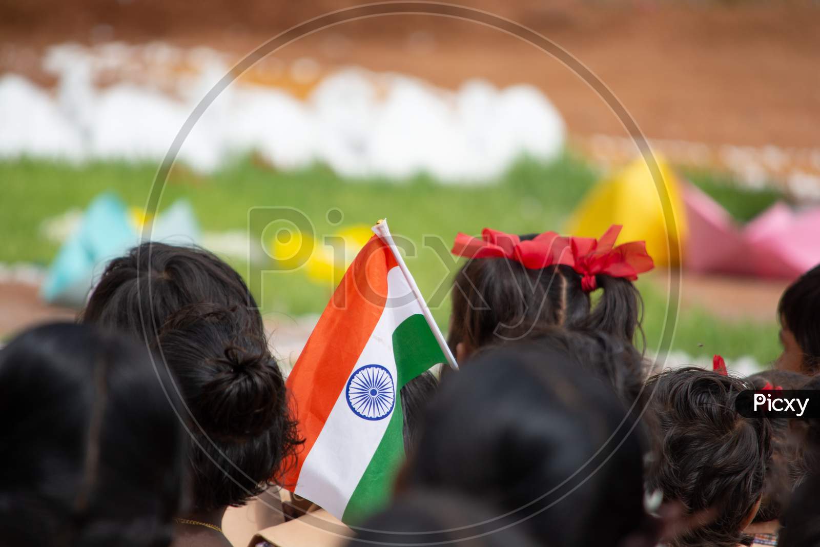 School Children Sat Ground By Holding Indian Flag In Hand During Independence Day Of India.
