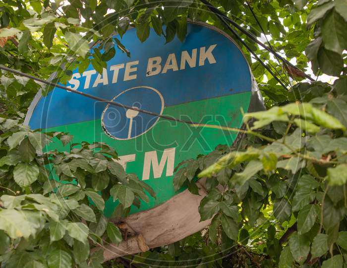 Bengaluru, India June 27,2019 : State Bank Of India Atm Board Covered With Trees.