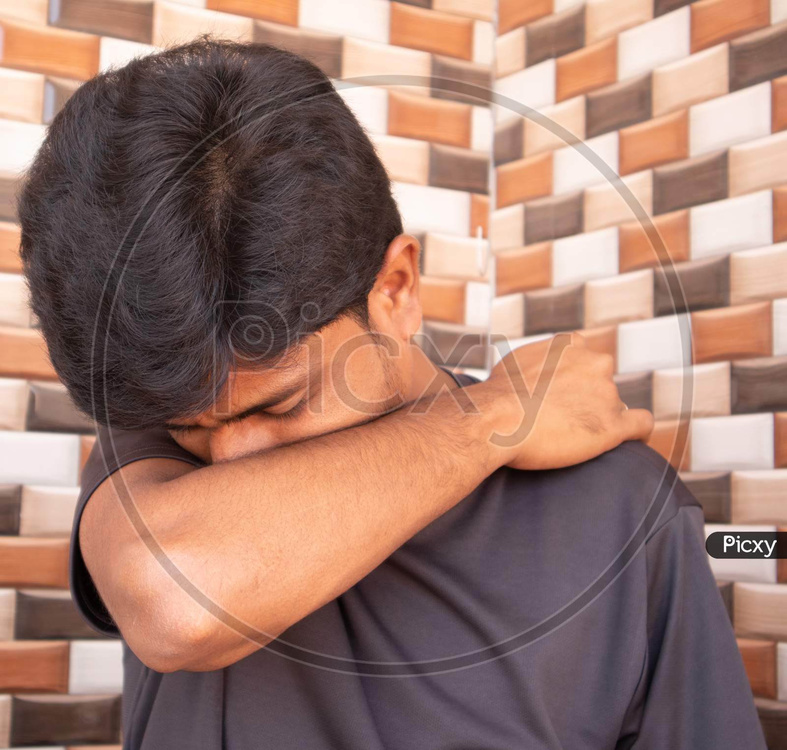 Indian Man Sneezing Virus Style. Indian Man Sneezing In Elbow.
