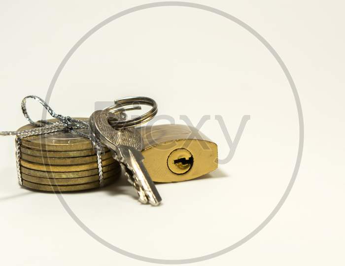 Indian 10 Rupee Coins Tied And Pad Locker With Keys On Isolated White Ackground