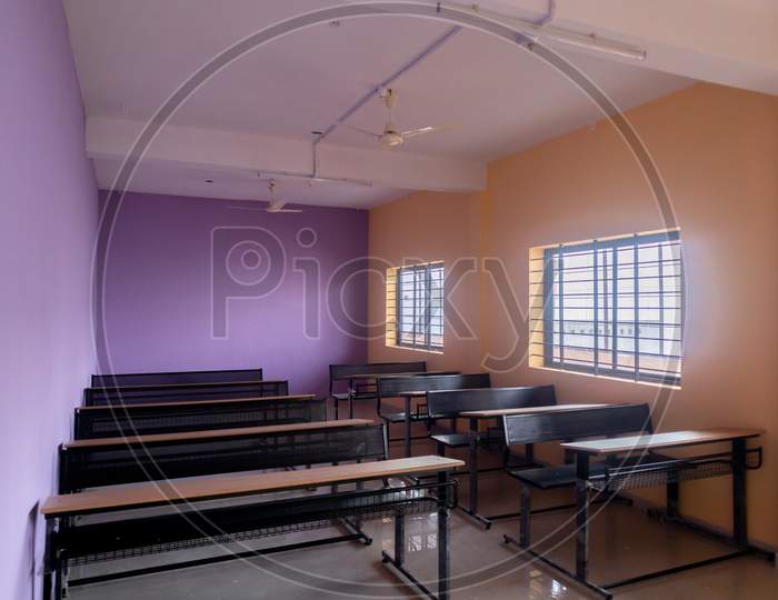 Empty Class Room And Desks With Colorful Walls