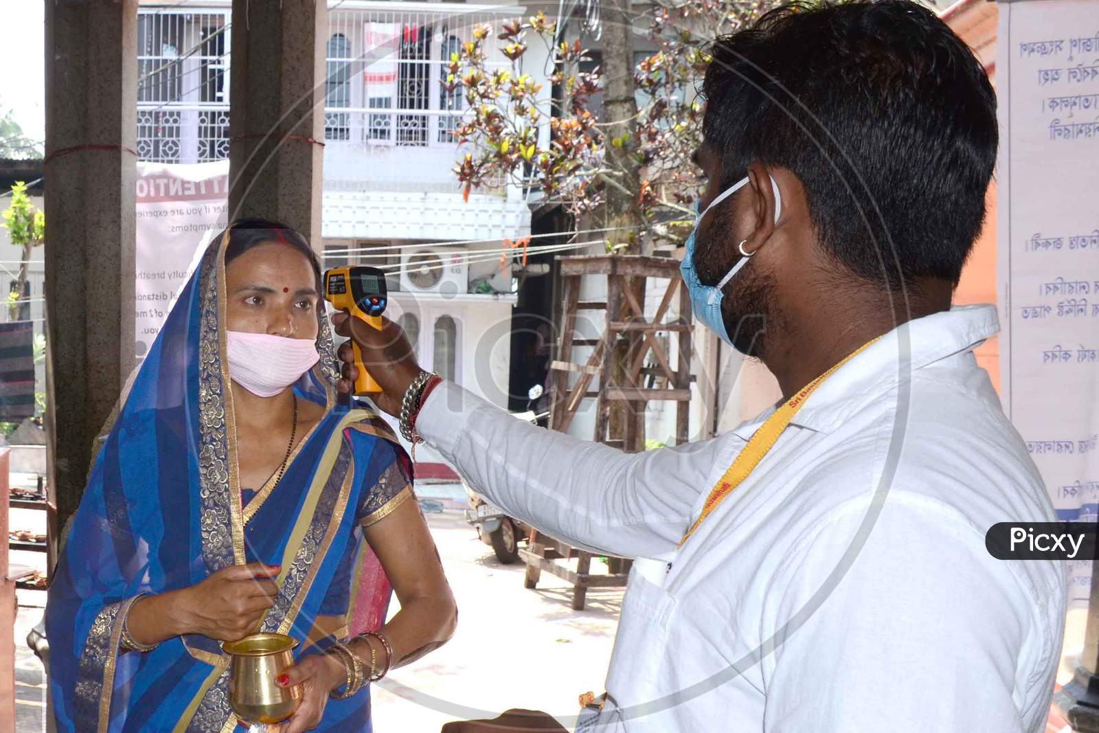 Thermal Screening Being Conducted Outside Sukerswar Temple After The Authorities Permitted Opening Of All Religious Places With Certain Restrictions, During The Fifth Phase Of Ongoing Covid-19 Lockdown, In Guwahati, Monday, June 8, 2020.
