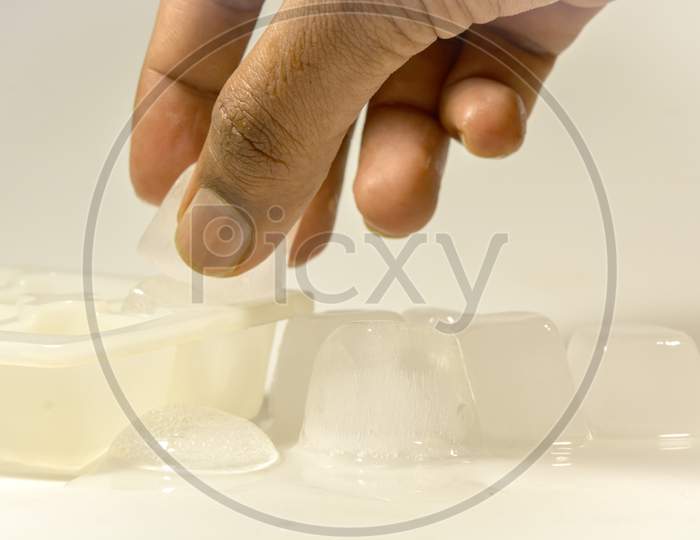A Person removing Ice Cubes from the Ice tray