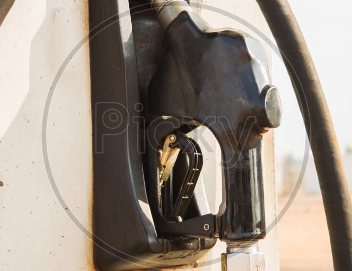 Fuel Oil Gasoline Dispenser At Petrol Filling Station.Holding Fuel Nozzle To Refuel Gasoline For Car.