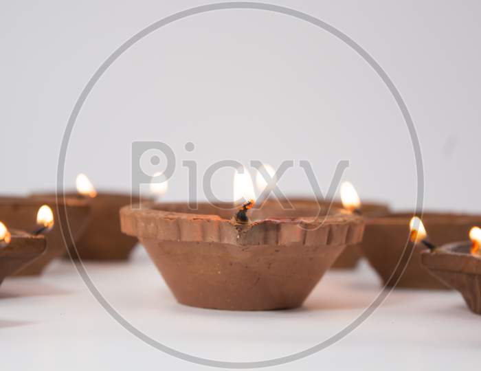 Closeup Of Diwali Terracotta Diyas On isolated  Background Which Are Used Lighting Up The House During Diwali Times