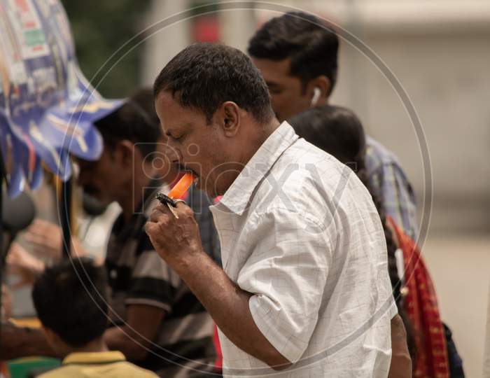 Bangalore, Karnataka India-June 04 2019 : Man Eating Ice Cream On Hot Sunny Day Near Vidhana Soudha At Bengaluru