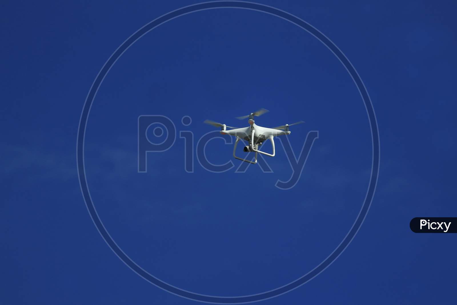 Drone with small action camera flying capture image in blue sky