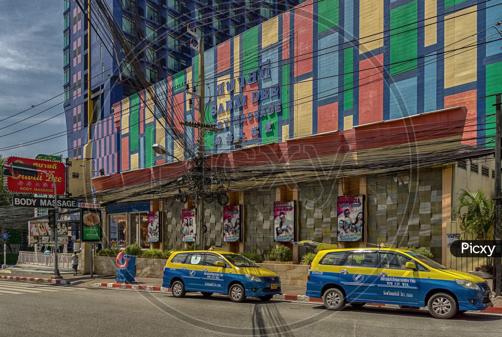 Pattaya,Thailand - October 21,2019;Second Road Two Taxis Were Standing In Front Of The Colorful Sabaai Massage,Which Is Spezialized In Adult Entertainment.