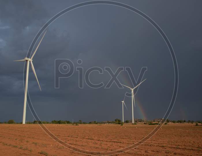 The landscape of an Agriculture Fields with Windmills and A Rainbow