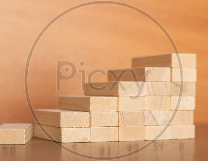 Wooden Toy Staircase With Broken First Staircase Step On Wooden Textured Background
