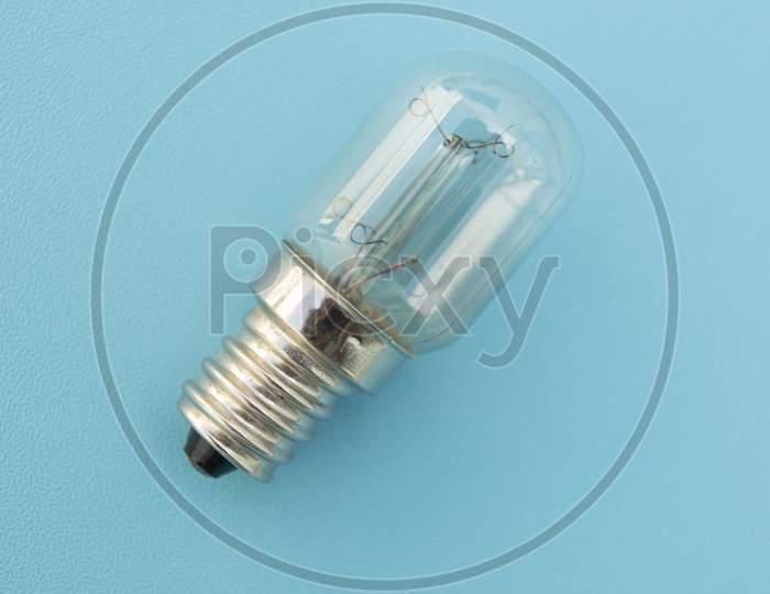 Close Up shot of an Electric Bulb isolated with Blue Background