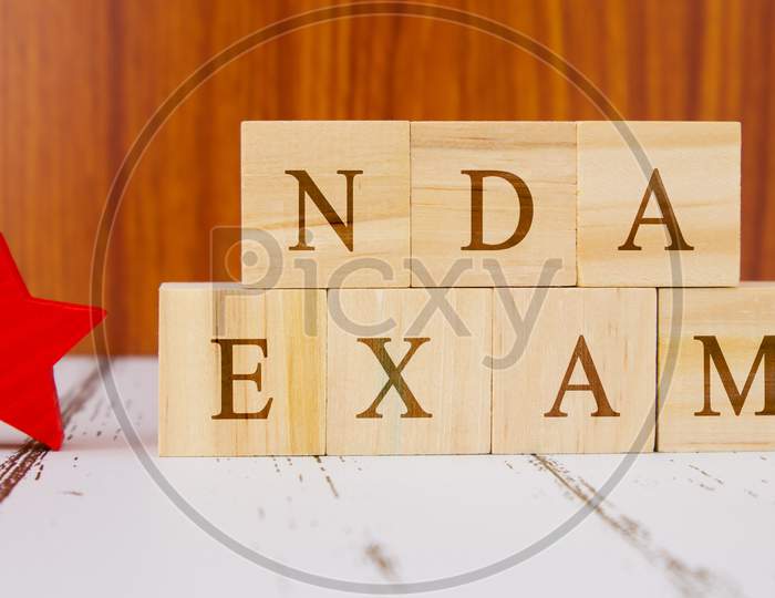 Concept Of Nda Exam Conducted In India For Recruitment On Wooden Block Letters.